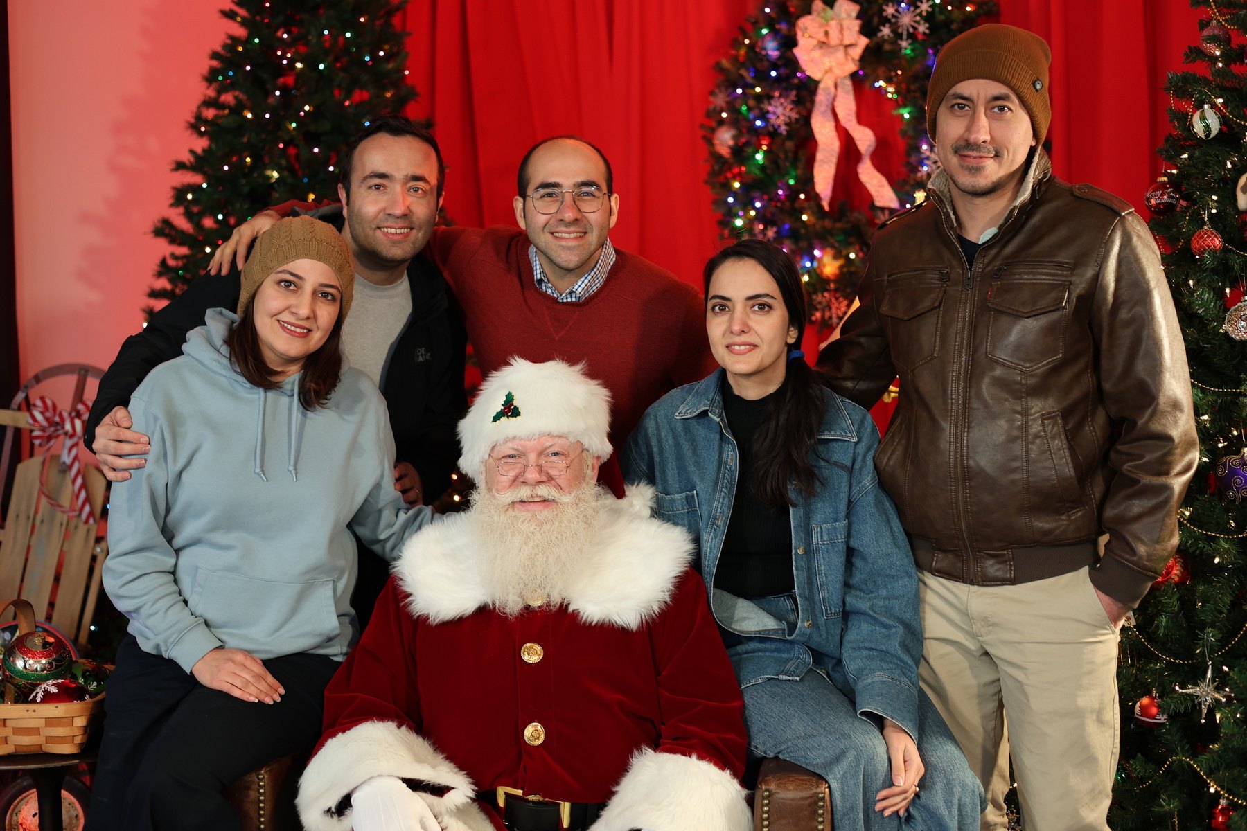 A group of visitors posing with Santa