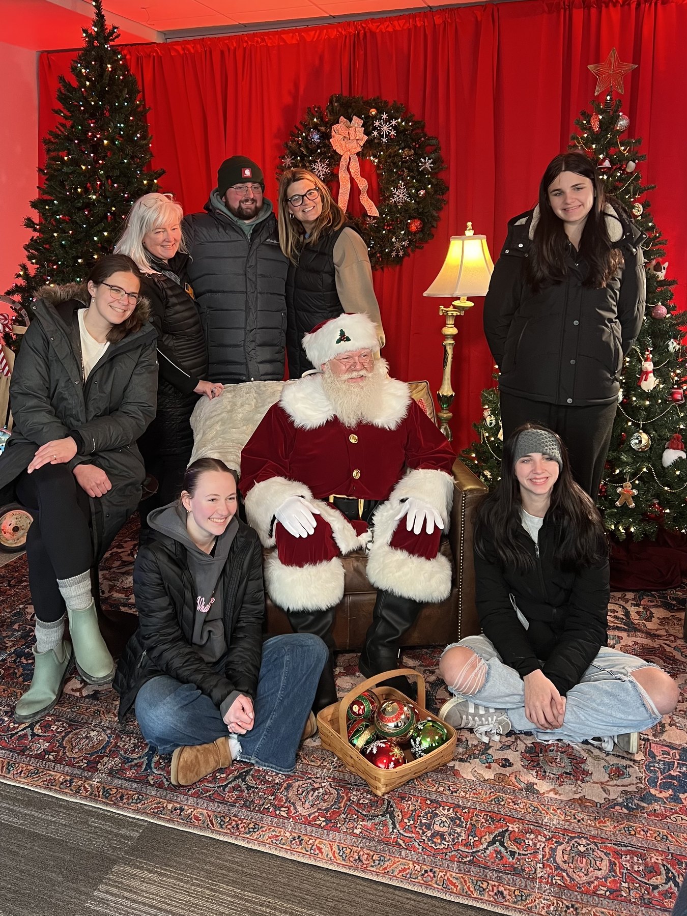 A large family group gathered around Santa