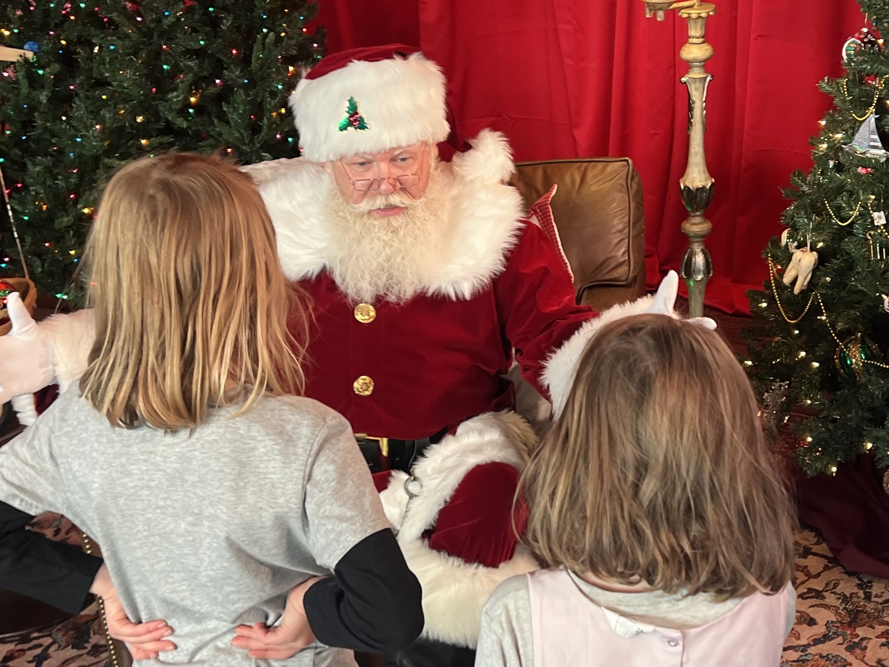 Santa greeting two young visitors