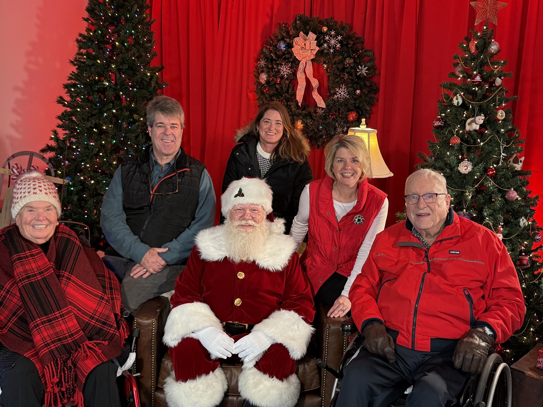 Santa with older visitors, including a guest using a wheelchair