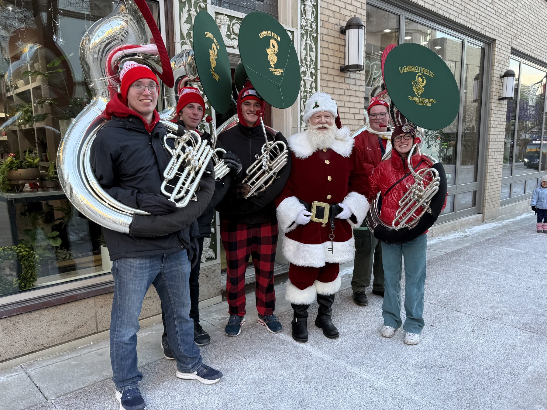 Santa posing with a brass band on State Street