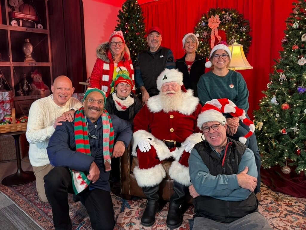 A large group posing with Santa